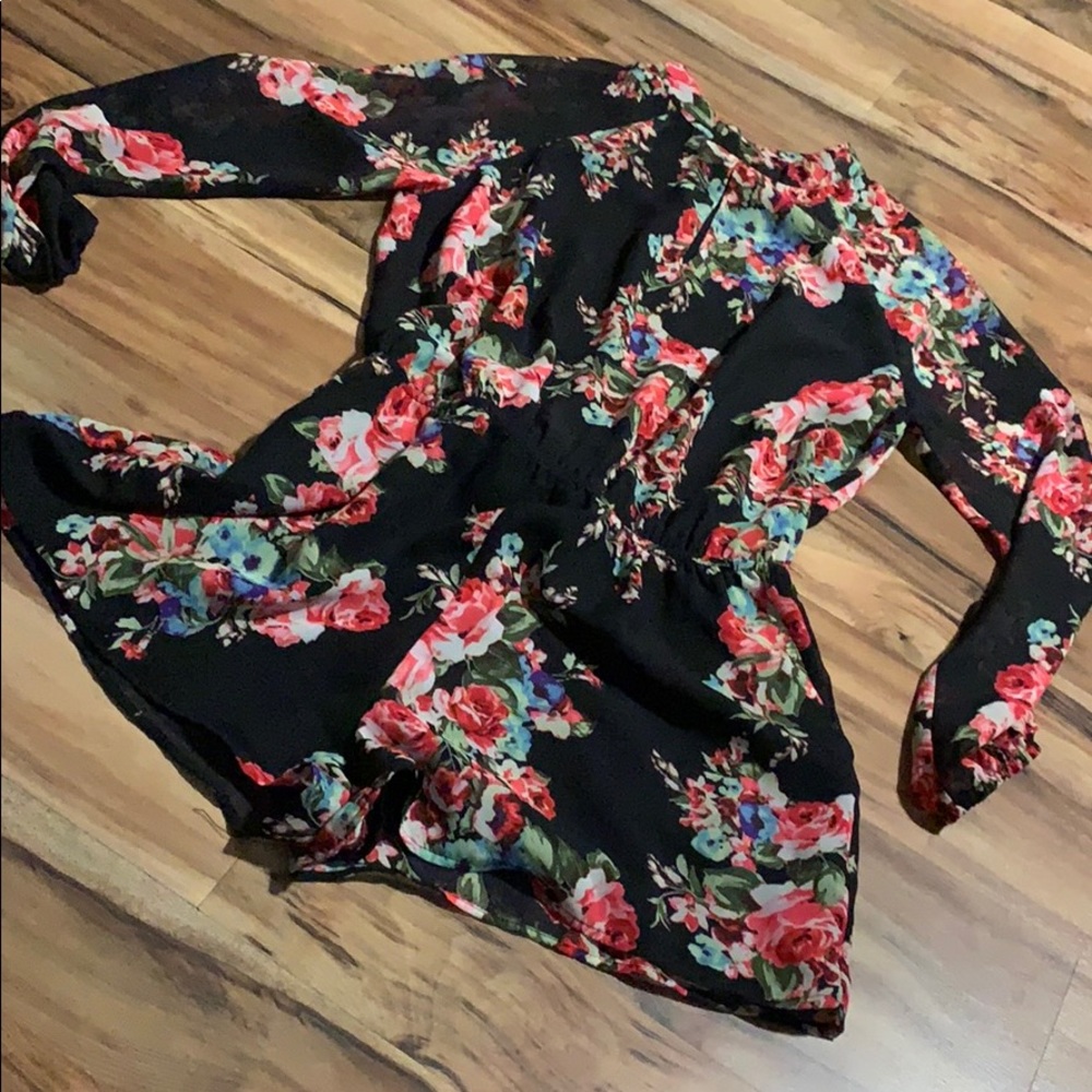 Floral romper with open back and peek-a-boo front.